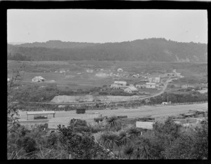 The settlement of Kakahi with railway station and sawmill in foreground and local houses and forest covered hills beyond, Manawatu-Whanganui Region