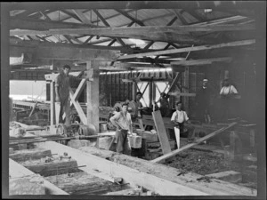 William Williams with unidentified workmen at Kakahi Sawmill with log cutting equipment, Kakahi Settlement, Manawatu-Whanganui Region