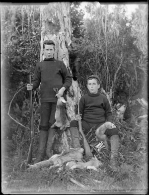 Edgar (left) and Owen Williams, with rifles and dead rabbits, Catlins district