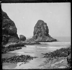 Large rock in the shallows of a beach, [Nugget Point], Catlins District