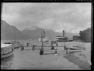 Passenger steam paddle boats, including other boats near jettys, on Lake Wakatipu, Queenstown-Lakes District