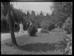 Unidentified people, standing on garden pathway, at a public garden area, Queenstown-Lakes District
