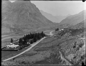 Unidentified valley, including farm houses and dirt road and mountains, [Head of Lake Wakatipu], Queenstown-Lakes District