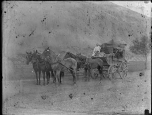 Stagecoach, including passengers inside carriage with stage driver and helper, sitting in the front part of carriage, Queenstown-Lakes District