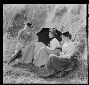 Unidentified women, sitting by side of mountain, unidentified location