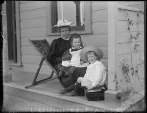 Portrait of Lydia Williams with sons (L to R) Owen and Edgar sitting on the veranda of their home Royal Terrace in the suburb of Kew, Dunedin City