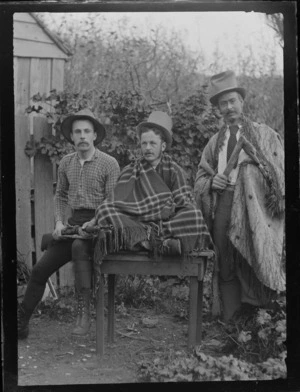 From left, William Williams (with rifle), Tom Wyatt and Elsdon Best (wearing a Korowai), in front of the Old Shebang, Cuba Street, Wellington