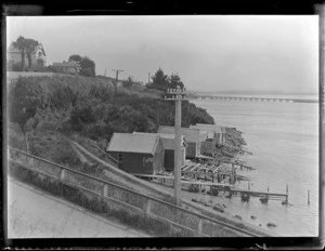 View of a railway bridge, houses and boat sheds