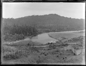 Fenced hill farm property with railway line in front of the Whanganui River and forest covered hills beyond, Kakahi Settlement, Manawatu-Whanganui Region