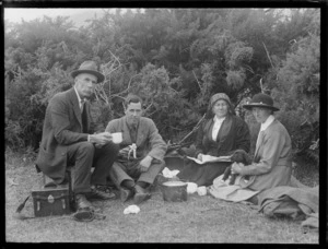 From left William, Edgar, Lydia and Alice Williams (holding a puppy), having a picnic, unknown location