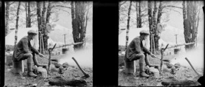 An unidentified man cooking over a campfire, location unidentified