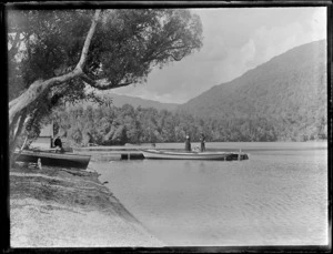 Lydia and William Williams with two small children in a canoe on unidentified lake, West Coast region