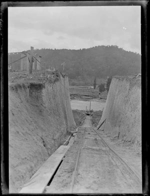 Looking down a steeply sloping timber tram track towards river, Kakahi, Manawatu-Whanganui region
