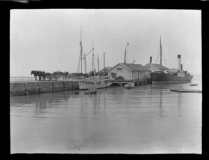 Small wharf, including boatsheds, boats, ships and horse and carts, unknown location