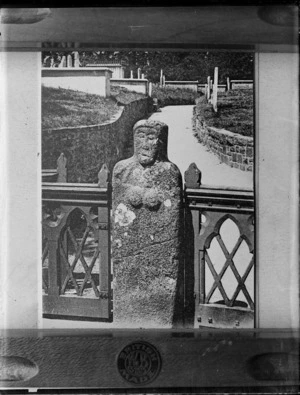 Copy of a photograph by W B & Sons of a [Celtic or Nun?] stone female effigy by a fence in an [English?] cemetery location, taken during Williams' European trip
