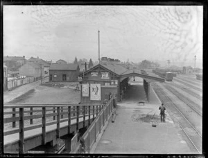 View of [probably Westport] Railway Station and rail yards with residential housing and an unknown river beyond, West Coast Region