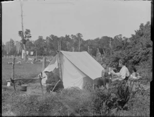 Edgar Williams (left), Owen Williams (right) and unidentified boy at their campsite next to farmland, with forest beyond, Catlins District, South Otago Region