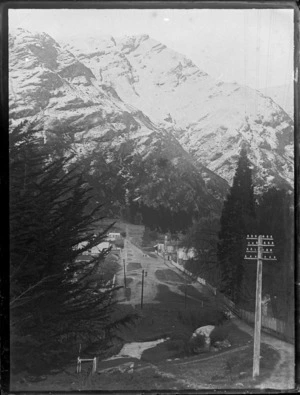 View down a Queenstown backstreet with residential buildings and a hotel to a snow covered Bob's Peak above, Central Otago Region