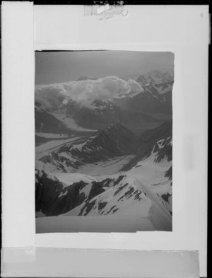 Copy negative of a unidentified snow covered mountain ridge, glaciers and valleys, South Island
