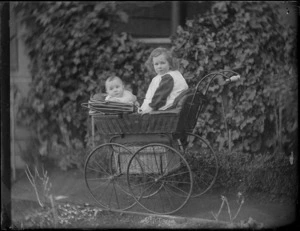 Baby Owen and Edgar Williams in a pram in front of the family house, 'View Bank', Maitland Street, Dunedin