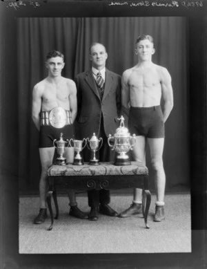 Boxers, Mr Hurne and Mr Stone, with unidentified trainer and trophies