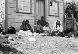 "Kapai-te-kai!" Maori group sitting outside a building