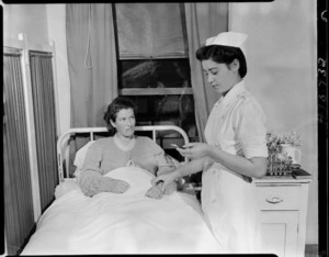 Nurse taking a patient's pulse and temperature, Memorial Hospital, Kaitaia - Photograph taken by Edward Percival Christensen