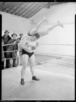 George Walker demonstrating a wrestling hold with Walter Millar, at Koolman's Gym, Wellington
