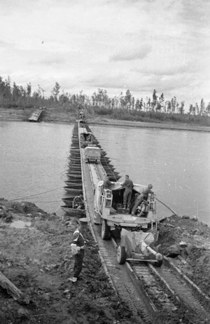 World War 2 New Zealand military vehicles crossing a pontoon bridge over the Po River, Italy
