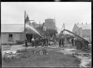 Group outside the fire damaged soap factory of Allender & Co, Petone