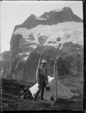 [Jack Murrell] outside a tent during Edgar Williams and Jack Murrell's climbing expedition, Fiordland National Park, South Island