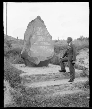 Stereographic image 2, an unidentified man in front of a War Memorial Boulder with inscription in honour of Cave, Cannington and Moutakaika District World War I & II Servicemen, Cave, South Canterbury Region