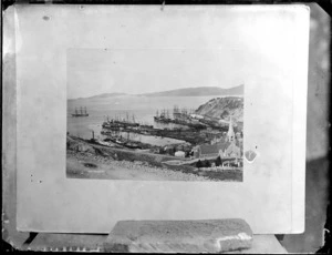 View of early Port Chalmers settlement, including wharf, Otago Harbour, buildings and church, Dunedin