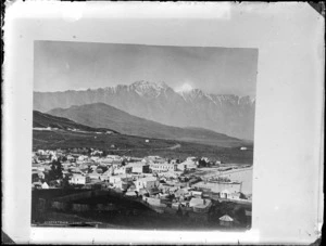 View of early Queenstown settlement, including Lake Wakatipu and mountains in background