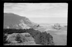 View of bay, hill and farmland, including farmhouse surrounded with trees, Kaituna area, Banks Peninsula, Canterbury