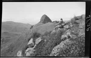 Landscape view, unidentified woman on top of hill looking out towards hills and mountain, Kaituna area, Banks Peninsula, Canterbury