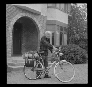 Edgar Williams with a push bike outside house with front brick entrance, [Christchurch]