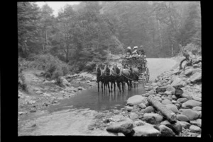 Stage coach with group of unidentified people aboard, showing horses going through Halpin Creek, Selwyn District, Canterbury Region