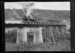 Goods and passenger steam train on bridge