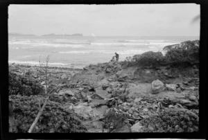 Alice Williams creating a pile of rocks, unidentified beach, Stewart Island (Rakiura)