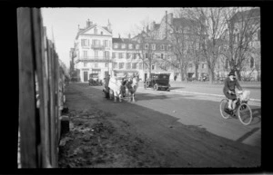 Street scene, including lady riding push-bike, man with his bullock and cart and the Hotel du Helder in the back ground, unknown location, France