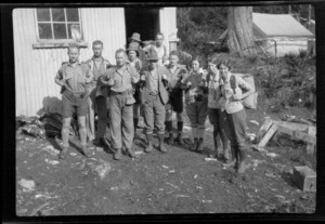 Trampers, with back packs, standing in front of hut, Howden Hut, Fiordland National Park, Southland