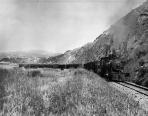 [Photographer unknown] :Engine No 11 of the Wellington and Manawatu Railway Company lifting a heavy mixed train up the steep gradient out of Thorndon