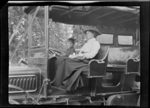 An unidentified woman and child sitting in a service car, Hamner Springs, Hurunui district, Canterbury region
