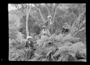 Three women, including Lydia Williams, right, and a young man, sitting in native forest, Hamner Springs, Hurunui district, Canterbury region
