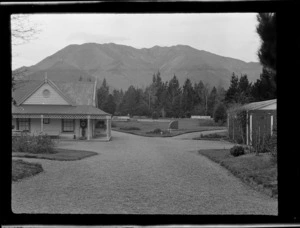 Hanmer Springs bath house and grounds, with trees and mountain in background, Canterbury Region