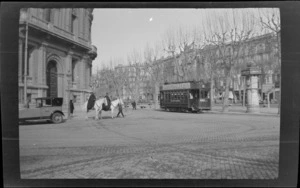 Street scene of two mounted policemen, a no.22 tram and a car, with buildings in the background, Barcelona, Spain