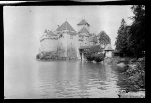Chillon Castle viewed from lakeside, including trees to the side, Lake Geneva, Switzerland