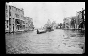 Small boat moored to steamboat in canal, Venice, Italy
