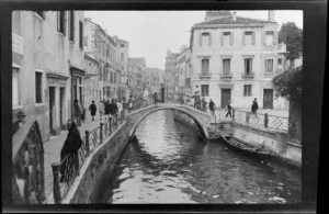 Bridge over canal, including buildings, pedestrians and walkway, Venice, Italy,